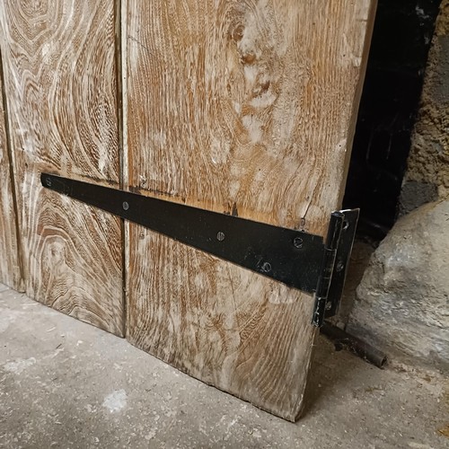 974 - An oak door, 176 x 82 cm, and two other doors (3)