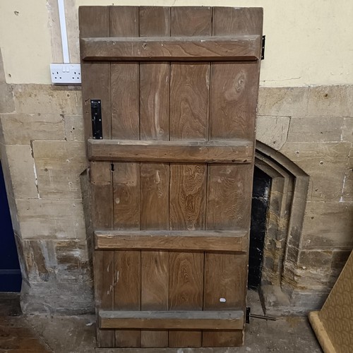 974 - An oak door, 176 x 82 cm, and two other doors (3)