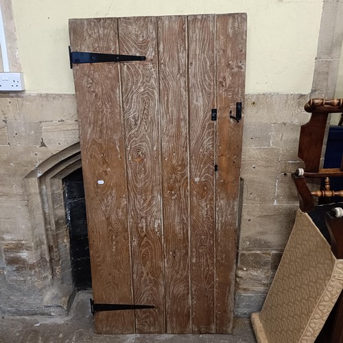 974 - An oak door, 176 x 82 cm, and two other doors (3)