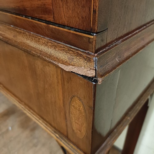 975 - A mahogany display cabinet, raised on square feet, 124 cm wide