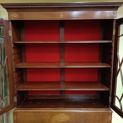 975 - A mahogany display cabinet, raised on square feet, 124 cm wide