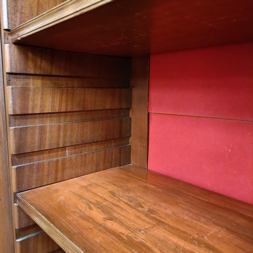 975 - A mahogany display cabinet, raised on square feet, 124 cm wide