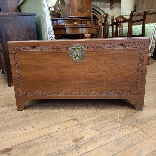 969 - A mahogany bow front chest, having two short and two long drawers, 85 cm wide, and a camphorwood che... 