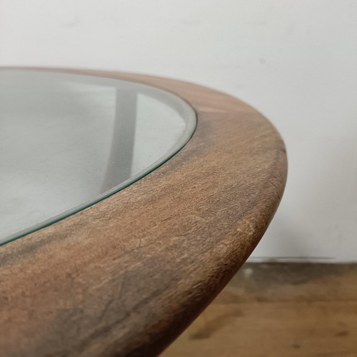 128 - A G-Plan teak and glass topped coffee table, 85 cm diameter