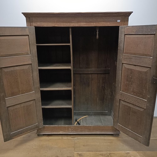 29 - An oak wardrobe with carved doors, 122 cm wide (2)