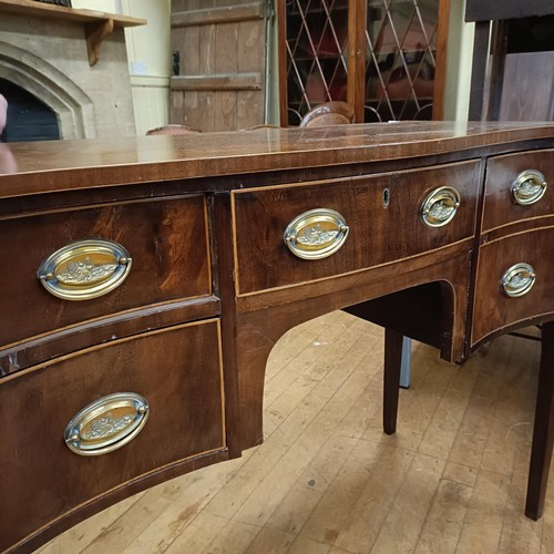 933 - A George III style serpentine sideboard, with a drawer, flanked by four short drawers, 122 cm wide