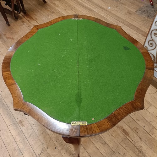 970 - A walnut serpentine folding card table, 85 cm wide