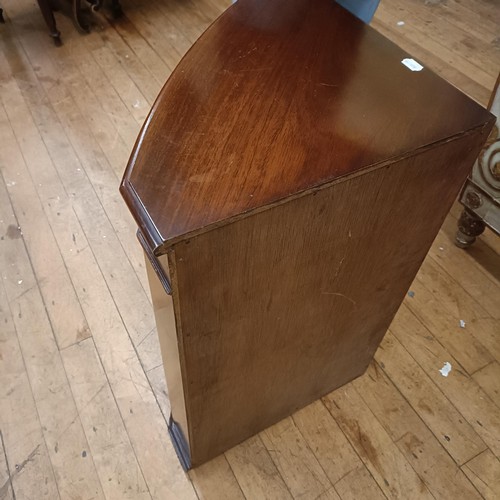 972 - A mahogany serpentine sideboard, 122 cm wide, two bedroom mirrors, a corner cabinet, and five chairs... 