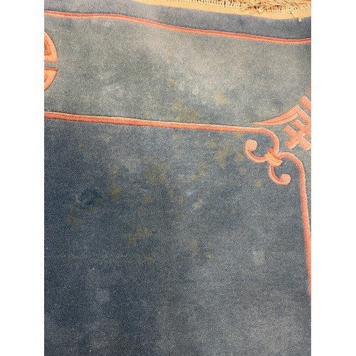 947 - A large Chinese blue ground carpet, 270 cm wide, another, and a red ground carpet (3)