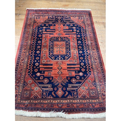 947 - A large Chinese blue ground carpet, 270 cm wide, another, and a red ground carpet (3)