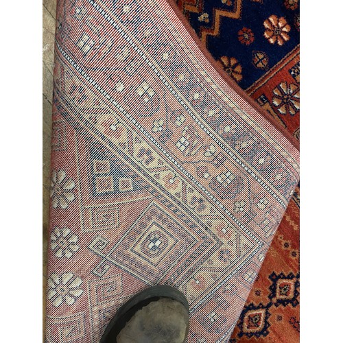 947 - A large Chinese blue ground carpet, 270 cm wide, another, and a red ground carpet (3)