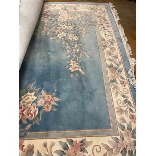 947 - A large Chinese blue ground carpet, 270 cm wide, another, and a red ground carpet (3)