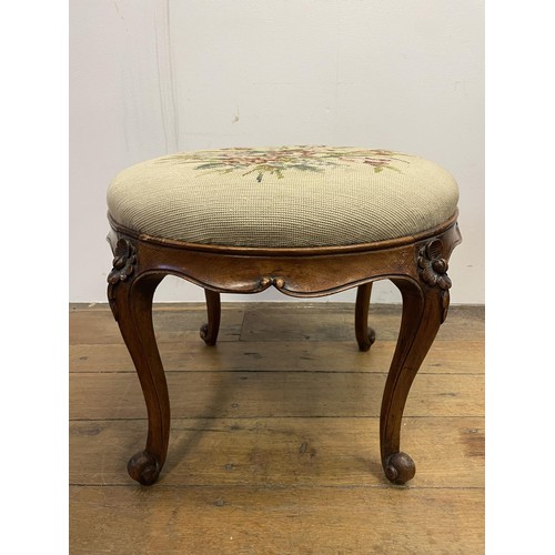 985 - A walnut stool, with a tapestry seat, 50 cm diameter