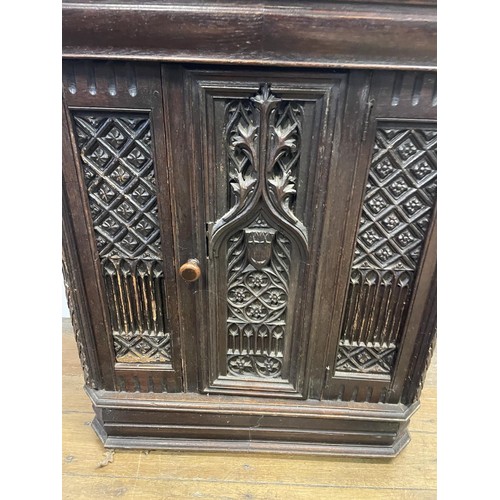 895 - A Gothic oak side cabinet, with a later marble top, 80 cm high x 71 cm wide