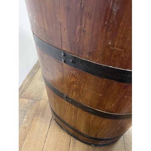 878 - A metal bound barrel, converted to a planter, 70 cm high x 56 cm wide