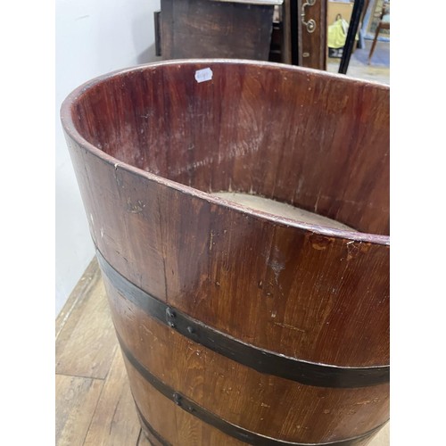 878 - A metal bound barrel, converted to a planter, 70 cm high x 56 cm wide