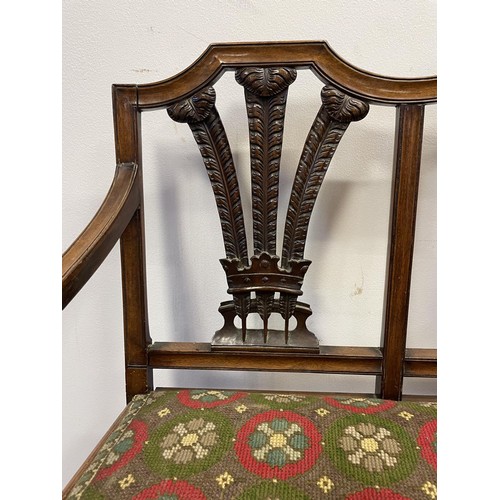 874 - An early 20th century child's mahogany three seater settee, with a pierced carved back, decorated fl... 