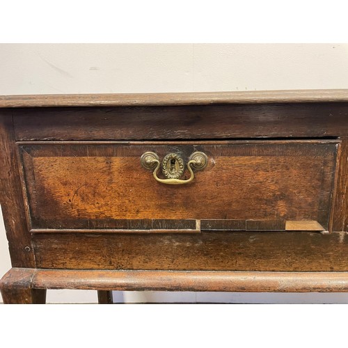 873 - A George III oak dresser base, having three drawers, 178 cm wide