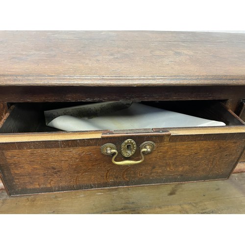 873 - A George III oak dresser base, having three drawers, 178 cm wide