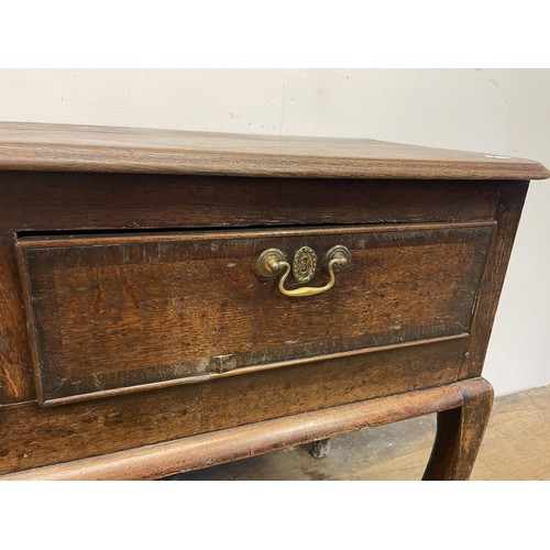 873 - A George III oak dresser base, having three drawers, 178 cm wide