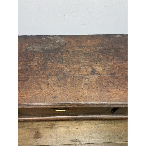 873 - A George III oak dresser base, having three drawers, 178 cm wide