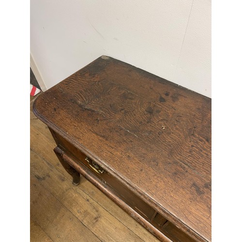 873 - A George III oak dresser base, having three drawers, 178 cm wide