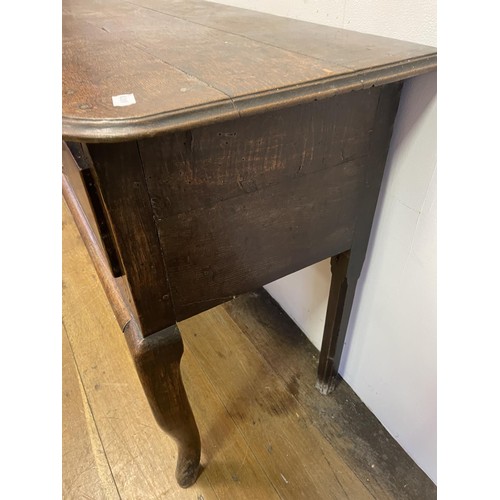 873 - A George III oak dresser base, having three drawers, 178 cm wide