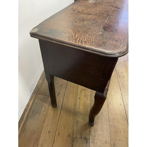 873 - A George III oak dresser base, having three drawers, 178 cm wide