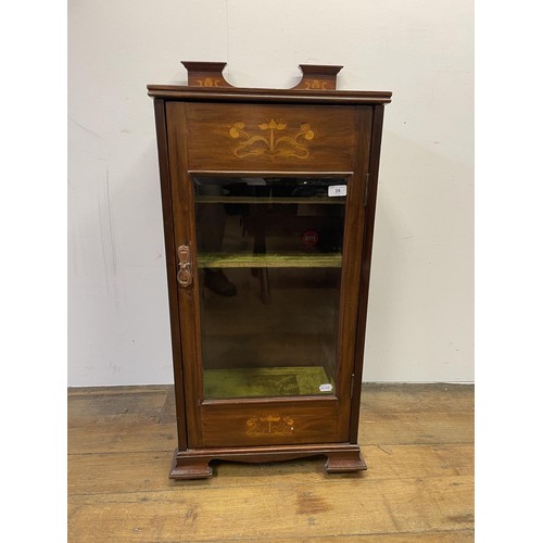 39 - An Art Nouveau style mahogany music cabinet, with a marquetry inlaid decoration, 47 cm wide, and a w... 