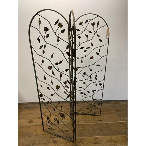 41 - A painted metal three fold wirework screen, decorated roses, each panel, 160 x 50 cm