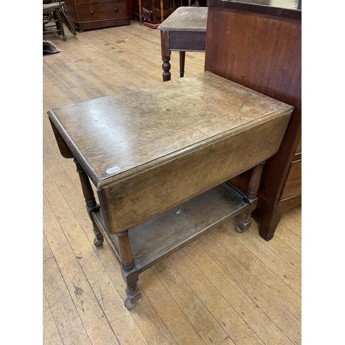 973 - A carved oak stool, 26 cm diameter, a painted cupboard, a two tier table, a drop leaf table, a wall ... 