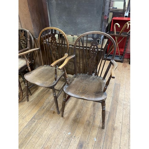 963 - A set of six oak wheel back dining chairs (4+2)