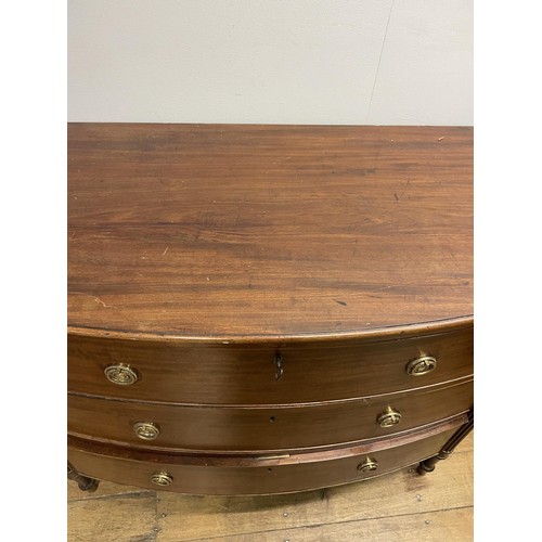 906 - A George III mahogany bow front chest, of three drawers, flanked by reeded column supports, 88 cm hi... 