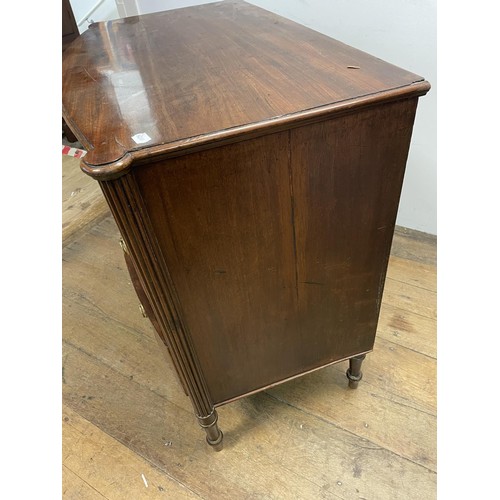 906 - A George III mahogany bow front chest, of three drawers, flanked by reeded column supports, 88 cm hi... 