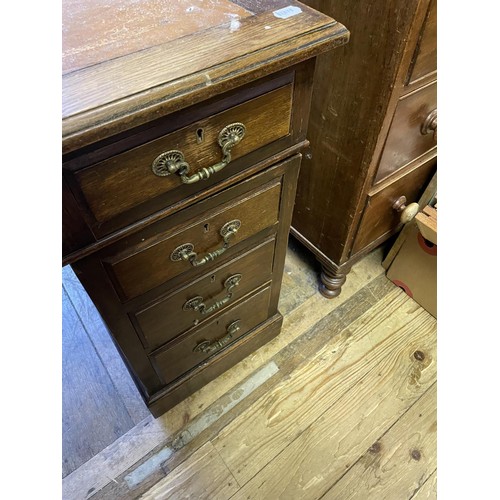 902 - An oak pedestal desk, having a nine drawer configuration, 122 cm wide