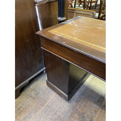 902 - An oak pedestal desk, having a nine drawer configuration, 122 cm wide