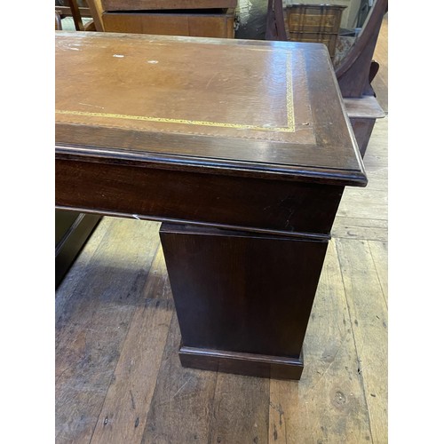 902 - An oak pedestal desk, having a nine drawer configuration, 122 cm wide