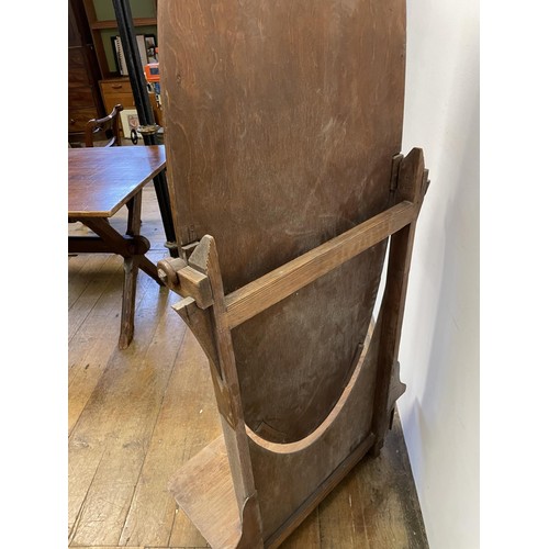 146 - An oak cheval mirror, 167 cm high