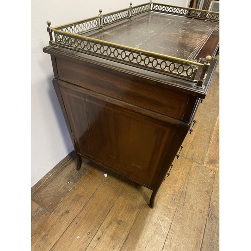 907 - An Edwardian mahogany pedestal desk, the top with a brass gallery above nine drawers, with satinwood... 