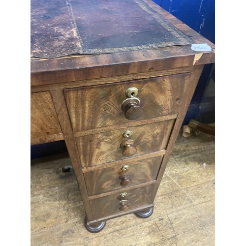 956 - A late 19th century mahogany kneehole writing desk, of nine drawer configuration, 105 cm wide