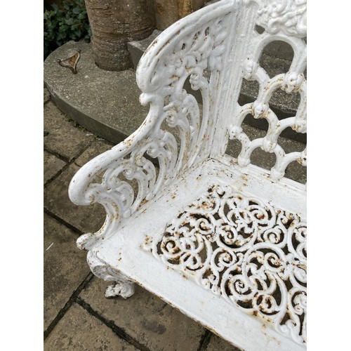 1009 - A white painted cast iron two seater garden bench, with pierced decoration and cabriole legs, 111 cm... 