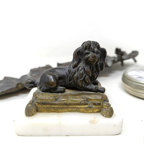 809 - A bronze figure, of a poodle seated on a cushion, on a marble base, a bronze leaf, with a frog, a si... 