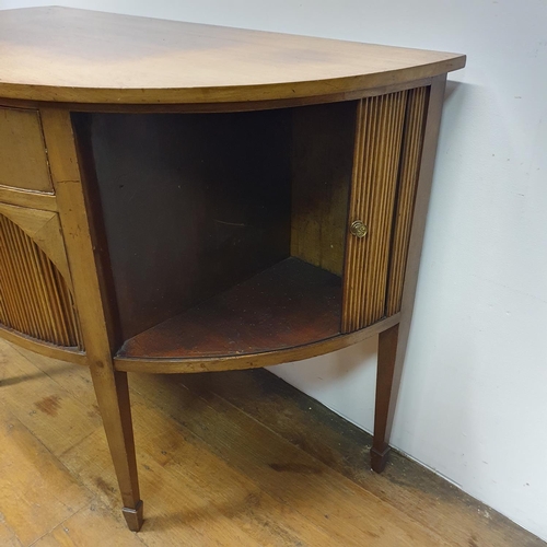 868 - A mahogany demi lune sideboard, with tambour fronted cupboards, 135 cm wide