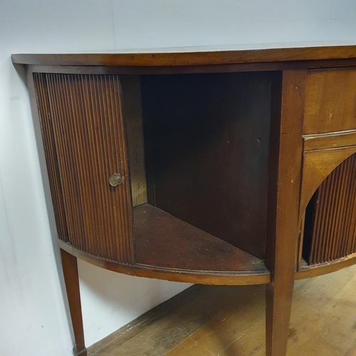 868 - A mahogany demi lune sideboard, with tambour fronted cupboards, 135 cm wide