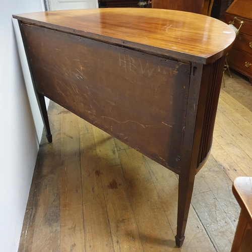 868 - A mahogany demi lune sideboard, with tambour fronted cupboards, 135 cm wide