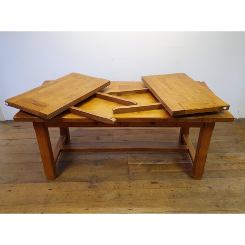 870 - An oak kitchen table, the top 180 x 87 cm, with two extra leaves, and a set of eight matching ladder... 