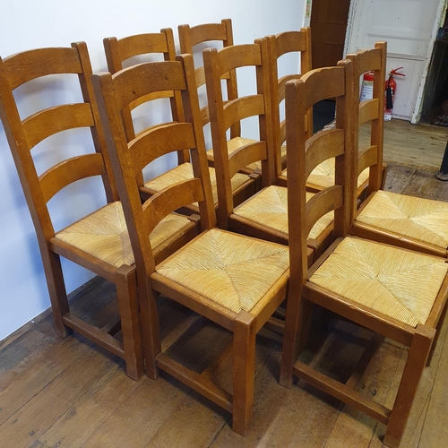 870 - An oak kitchen table, the top 180 x 87 cm, with two extra leaves, and a set of eight matching ladder... 