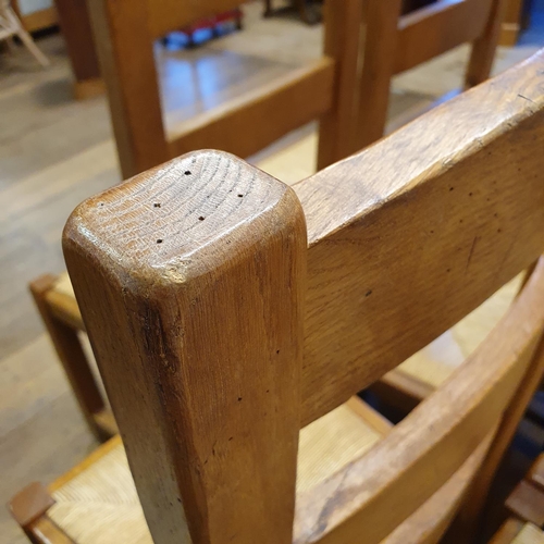 870 - An oak kitchen table, the top 180 x 87 cm, with two extra leaves, and a set of eight matching ladder... 