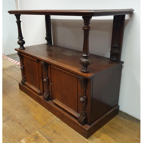 879 - A mahogany buffet, the base with two cupboard doors, 130 cm wide