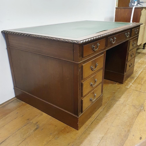 896 - A mahogany pedestal desk, of a nine drawer configuration, 150 cm wide